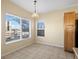 Cozy dining area features tile floors, natural light, and simple chandelier for everyday meals at 4747 S Balsam Way # 104, Littleton, CO 80123