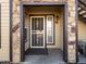 Close up view of the entrance with stone accents and storm door at 4747 S Balsam Way # 104, Littleton, CO 80123
