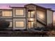 Inviting exterior with stone accents, balcony, well-maintained landscaping, and stair access to the upper units at 4747 S Balsam Way # 104, Littleton, CO 80123