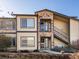 Inviting exterior with stone accents, balcony, well-maintained landscaping, and stair access to the upper units at 4747 S Balsam Way # 104, Littleton, CO 80123