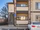 Exterior building view showing handicap parking, stairs to upper units, stone accents, and balcony at 4747 S Balsam Way # 104, Littleton, CO 80123