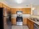 Bright kitchen features stainless steel appliances and wood cabinetry at 4747 S Balsam Way # 104, Littleton, CO 80123