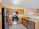 This well-lit kitchen offers stainless steel appliances and wood cabinets at 4747 S Balsam Way # 104, Littleton, CO 80123