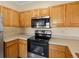 This kitchen features light wood cabinetry, stainless steel appliances, and ample counter space at 4747 S Balsam Way # 104, Littleton, CO 80123