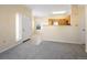 Open-concept living room with cozy carpet, view of the kitchen, and natural light at 4747 S Balsam Way # 104, Littleton, CO 80123