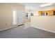 Open-concept living room with cozy carpet, view of the kitchen, and natural light at 4747 S Balsam Way # 104, Littleton, CO 80123