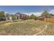 Large, grassy backyard with a red deck and wooden fence for privacy at 17979 E Oxford Pl, Aurora, CO 80013