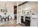 Kitchen with stainless appliances, white cabinets, open to dining area at 17979 E Oxford Pl, Aurora, CO 80013
