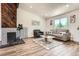 Bright living room featuring hardwood floors, comfortable seating, and a decorative fireplace at 17979 E Oxford Pl, Aurora, CO 80013