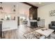 Spacious living room with hardwood floors, stylish decor, and a modern fireplace at 17979 E Oxford Pl, Aurora, CO 80013