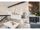 Open-concept living room featuring a fireplace, wood floors, and stainless steel appliances at 17979 E Oxford Pl, Aurora, CO 80013