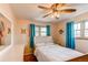 Bedroom with white furniture and vibrant blue curtains at 2785 Skyline Dr, Westminster, CO 80030