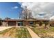 Charming brick ranch-style home with attached garage, well-maintained lawn, and mature trees at 2785 Skyline Dr, Westminster, CO 80030