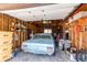 Cluttered garage with blue car and shelving for storage at 2785 Skyline Dr, Westminster, CO 80030