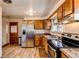 Kitchen with stainless steel fridge, wooden cabinets, and sink at 2785 Skyline Dr, Westminster, CO 80030