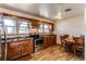 Kitchen with tile floors, stainless steel oven and wooden cabinets at 2785 Skyline Dr, Westminster, CO 80030