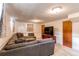 Spacious living room with plush sectional couch and media center at 2785 Skyline Dr, Westminster, CO 80030
