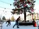 Outdoor ice rink with skaters and buildings in the background at 810 S Vance St # C, Lakewood, CO 80226