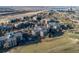 Aerial view of the property showcasing manicured grounds, nearby golf course, mature trees, and building rooftops at 13961 E Marina Dr # 409, Aurora, CO 80014