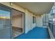 Balcony featuring sliding glass doors into the living room and blue outdoor carpet at 13961 E Marina Dr # 409, Aurora, CO 80014