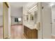 Bathroom featuring a vanity, updated lighting, and a view to the main living area at 13961 E Marina Dr # 409, Aurora, CO 80014