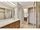Bathroom with wood cabinets, light countertops, and a large mirror at 13961 E Marina Dr # 409, Aurora, CO 80014