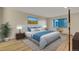 Spacious bedroom featuring modern decor, a large bed, and a picturesque view from the window at 13961 E Marina Dr # 409, Aurora, CO 80014