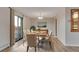 Elegant dining room featuring a modern table set, wood-look floors, and a sliding glass door to a balcony at 13961 E Marina Dr # 409, Aurora, CO 80014