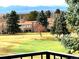 Scenic view of a golf course and residences with the Denver skyline and snowy mountains in the distance at 13961 E Marina Dr # 409, Aurora, CO 80014