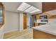 Bright kitchen featuring a stainless steel refrigerator, modern appliances, and wood cabinets at 13961 E Marina Dr # 409, Aurora, CO 80014