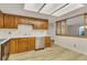 Charming kitchen with wood cabinets, white tile backsplash, stainless steel appliances, and bright lighting at 13961 E Marina Dr # 409, Aurora, CO 80014