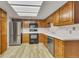 Well-lit kitchen with stainless steel appliances, light countertops and wood cabinets at 13961 E Marina Dr # 409, Aurora, CO 80014