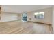 Bright living room with wood floors, a sliding glass door and large window at 13961 E Marina Dr # 409, Aurora, CO 80014