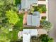 This aerial view showcases a home with a large yard, patio, and mature trees at 236 W Sycamore Ln, Louisville, CO 80027