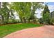 Backyard with paved patio, lush lawn, and mature trees at 236 W Sycamore Ln, Louisville, CO 80027