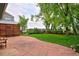 Landscaped backyard with patio, grass, and mature trees at 236 W Sycamore Ln, Louisville, CO 80027