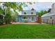 Backyard with patio, lawn, and a charming turquoise two-story house at 236 W Sycamore Ln, Louisville, CO 80027