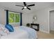 Bright bedroom with a large window overlooking lush greenery, complemented by blue accents at 236 W Sycamore Ln, Louisville, CO 80027