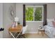 Comfortable bedroom featuring a desk area and a window with views of lush trees at 236 W Sycamore Ln, Louisville, CO 80027