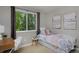 Bright bedroom with a cozy bed, a window with view of trees, and a desk area at 236 W Sycamore Ln, Louisville, CO 80027