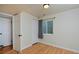 Bright bedroom featuring wood laminate flooring, multiple closets, and a window with a view at 236 W Sycamore Ln, Louisville, CO 80027