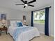 Comfortable bedroom with large window, ceiling fan, and blue accents at 236 W Sycamore Ln, Louisville, CO 80027