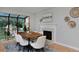 Dining room with a fireplace and a view of the outdoor greenery through the solarium windows at 236 W Sycamore Ln, Louisville, CO 80027