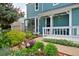 Home's entry with a well-maintained porch and beautiful landscaping at 236 W Sycamore Ln, Louisville, CO 80027