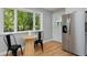 Cozy kitchen nook with stainless steel refrigerator, table, chairs, and scenic window view to the outside at 236 W Sycamore Ln, Louisville, CO 80027
