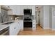 Well-equipped kitchen with stainless steel oven, microwave, and quartz countertops with ample storage at 236 W Sycamore Ln, Louisville, CO 80027