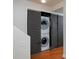 Convenient laundry area featuring a stacked washer and dryer set behind sliding doors at 236 W Sycamore Ln, Louisville, CO 80027
