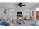 Bright living room with modern furnishings, wood floors, ceiling fan, and large windows for natural light at 236 W Sycamore Ln, Louisville, CO 80027