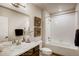 Well-lit bathroom featuring vanity with sink and mirror next to tub and shower at 917 W 129Th Pl, Denver, CO 80234
