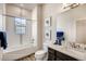 A well-lit bathroom with a tiled shower-tub, modern fixtures, and stylish decor, providing a relaxing experience at 917 W 129Th Pl, Denver, CO 80234
